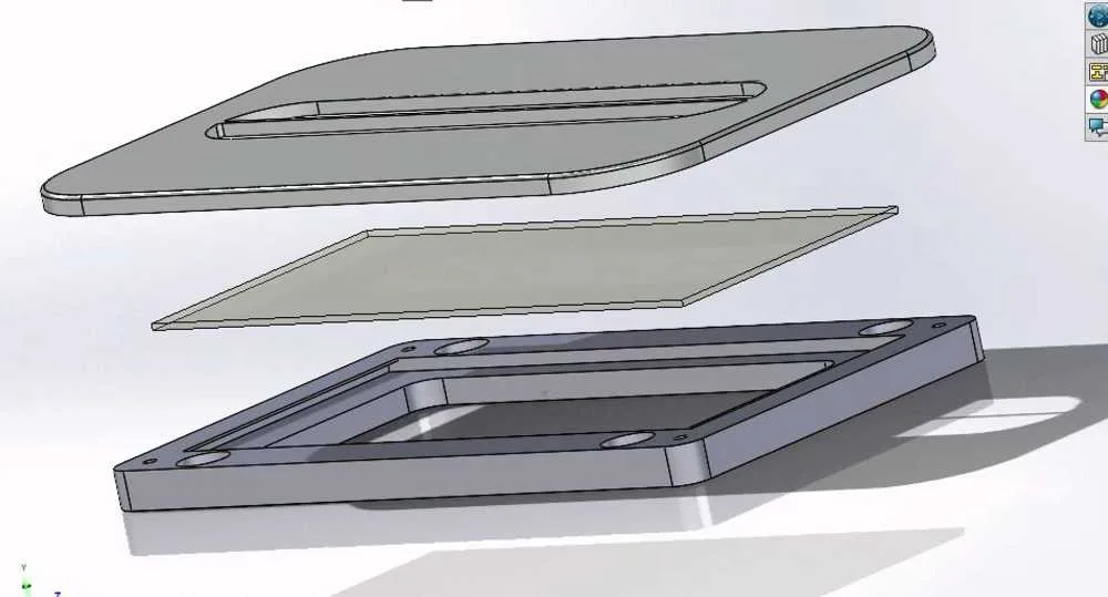 SolidWorks exploded view — faceplate, filter sheet, and magnetic housing frame in a vertical stack